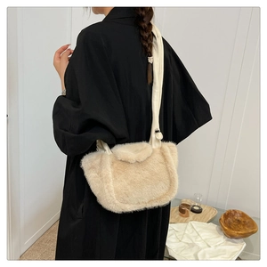 Close-up of fluffy faux fur shoulder bag in beige with high-quality leather straps