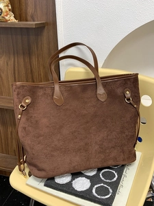 Brown leopard print suede tote bag with drawstring detail on a chair in a retro setting