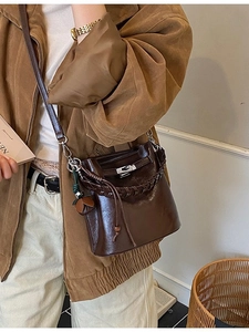Vintage brown leather bucket bag with metallic twist lock and braided handle for women