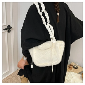 Close-up of white plush shoulder bag featuring a unique gathered ruched cloud strap