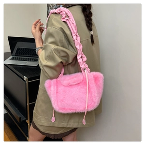 Detail view of pink faux fur shoulder bag featuring ruffled straps and soft plush texture