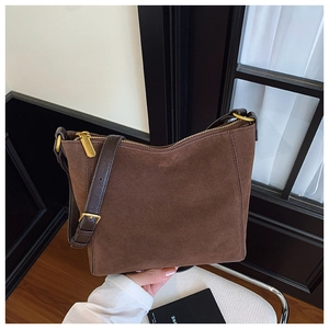 Close-up of coffee brown suede tote bag featuring retro gold zipper and adjustable strap