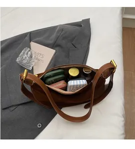 Interior view of brown suede dumpling bag showing spacious storage for daily items