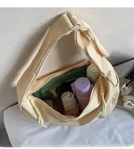 Spacious interior of a yellow fabric crossbody bag showing capacity for daily essentials