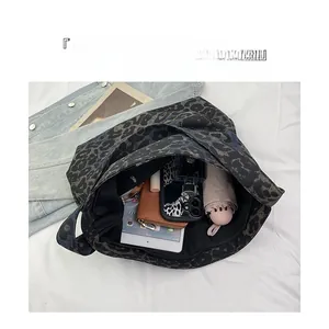Top view of large leopard print tote bag interior showing organized compartments and items