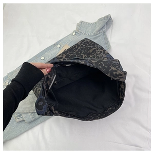 Detailed view of the leopard print tote bag interior showing spacious lining and zipper pocket