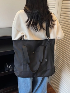 Large capacity black nylon tote bag with dual handles and adjustable strap for women
