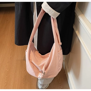 Detailed macro view of pink waffle fabric texture and tassel drawstring on the bag