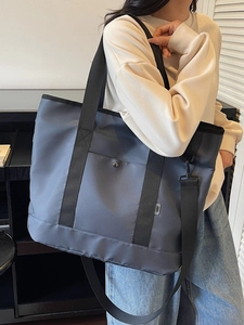 Large capacity canvas tote bag with contrast black straps and adjustable shoulder strap