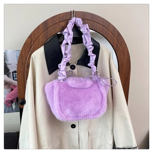 Detail of lavender plush handbag featuring soft faux fur texture and pleated handle