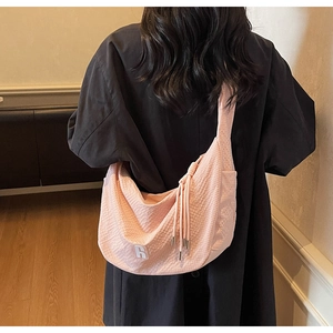 Detail of pink waffle fabric texture and tassel on large shoulder bag with R logo