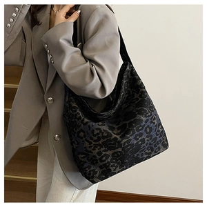 Detailed macro view of retro leopard print fabric texture on a large tote bag