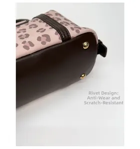 Detail of leopard print bag bottom with brown leather and four gold metal protective rivets