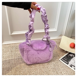 Close-up of lavender purple faux fur handbag with stylish pleated handle and soft texture