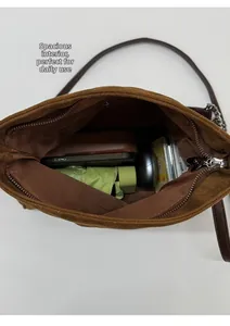 Detail view of large interior capacity for brown suede shoulder bag with umbrella and phone