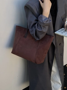 Minimalist deep brown suede tote bag for women with large capacity shown on model wearing grey coat