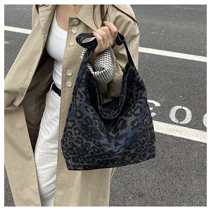 Close-up of a leopard print tote bag with a soft texture and urban style fashion details