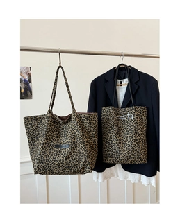 Detail of leopard print tote bags in two sizes with stylish English embroidery and canvas texture