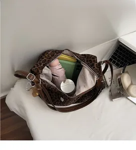 Detailed interior view of a leopard print tote bag showing large storage capacity