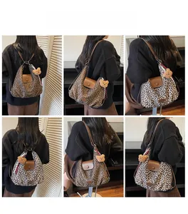 Detail view of large leopard print tote bags in brown and black-white with plush bear charm