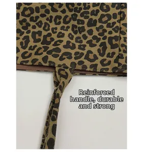 Close-up of leopard print tote bag reinforced handles for heavy duty weight capacity