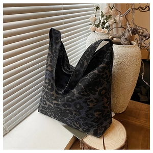 Close-up of leopard print tote bag with thick fabric texture and wide shoulder strap