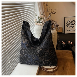 Detail of leopard print tote bag in a cozy home setting with warm lighting