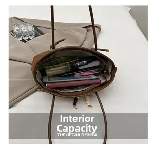 Detailed view showing the large internal capacity of the brown suede shoulder bag