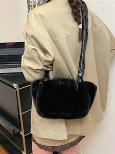 Large black faux fur shoulder bag with soft plush texture and thick leather strap