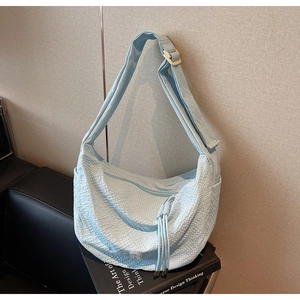 Detail shot of the light blue bubble textured hobo bag with adjustable wide shoulder strap