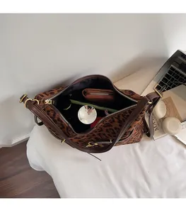 Top view of spacious leopard print bucket bag showing interior storage with essentials