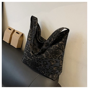 Detail view of large leopard print tote bag with soft structure and wide shoulder strap