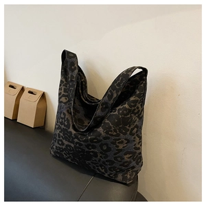 Detail of vintage leopard print tote bag made of durable canvas on leather surface