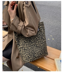 Detail of leopard print tote bag paired with a trench coat for a stylish autumn look