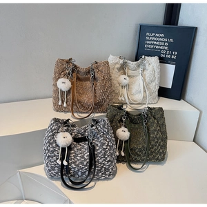 Detail showing plush tote bags in four colors with leather chain straps and fuzzy charms