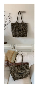 Detail of leopard print tote bag showing thick canvas texture and durable dual handles