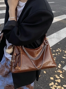 Vintage brown leather crescent underarm bag with silver chain and plush puppy charm