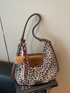 Retro leopard print canvas tote bag with brown leather flap and adjustable strap
