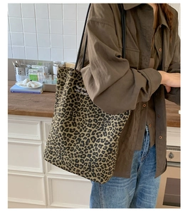 Close-up of leopard print canvas tote bag with black straps in a modern kitchen setting