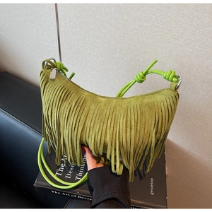 Detailed close-up of avocado green suede dumpling bag with elegant long tassels