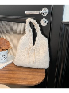 Minimalist cream knit handbag featuring a cute bow and textured chunky woven pattern