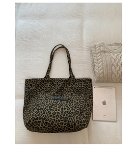 Detailed top view of large leopard print canvas tote bag with tablet and cozy sweater