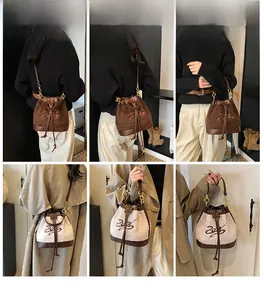 Detail of plush bucket bag with number 26 embroidery and leather drawstring closure