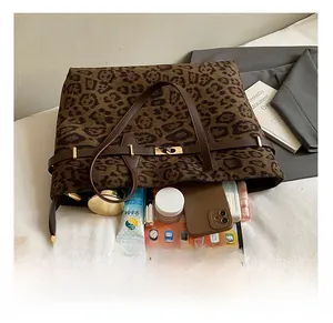 Spacious leopard print tote bag interior showing capacity for tablets and cosmetics