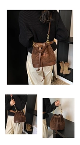Detailed view of plush lamb wool bucket bag with drawstring and embroidered 25 design