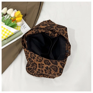 Close-up of leopard print tote bag interior showing zipper pocket and magnetic snap button