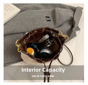 Internal capacity of plush bucket bag showing storage for makeup and daily items
