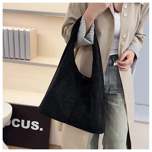 Detail of minimalist black suede tote bag showing premium matte texture and spacious design