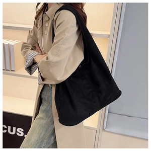 Close-up of the black corduroy tote bag showing its soft texture and large capacity
