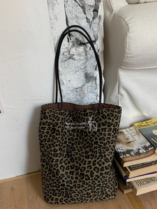 Leopard print canvas tote bag with embroidery on a vintage home lifestyle background